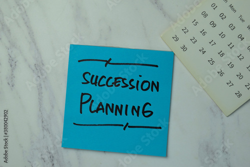 Succession Planning write on sticky notes isolated on office desk.