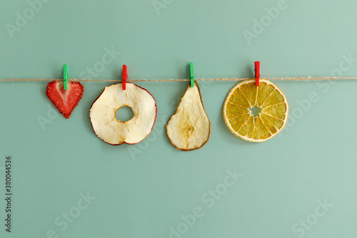 Fruit chips are dried on a rope.
