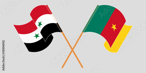 Crossed and waving flags of Cameroon and Syria