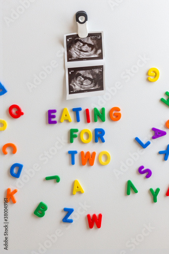 Fetal ultrasound image and magnetic letters on a fridge photo