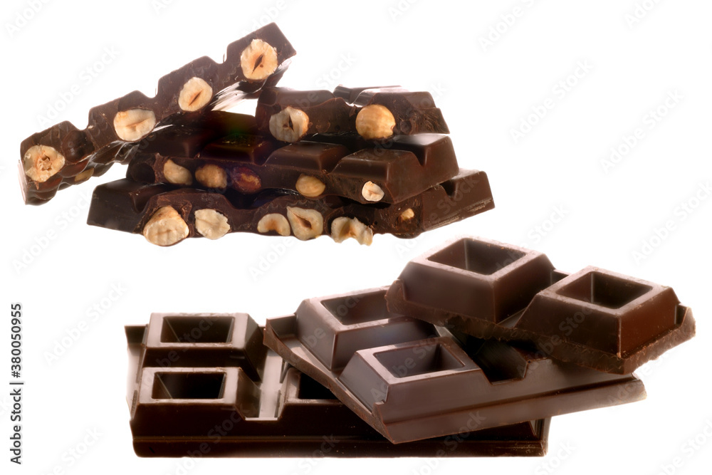 set of broken dark chocolate bars with exposed hazelnuts isolated on white set of broken dark chocolate bars with exposed hazelnuts isolated on white