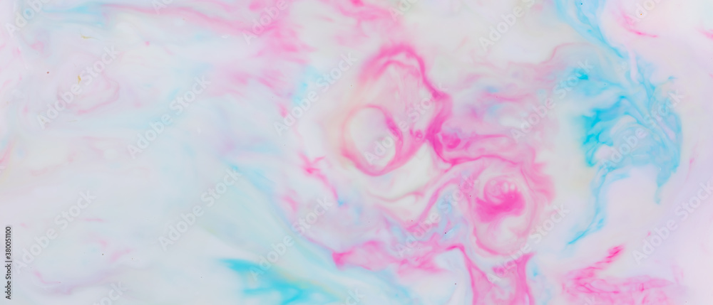 Fluid art. Multicolored background from liquid. Photography of colored spots on liquid. Abstract pattern