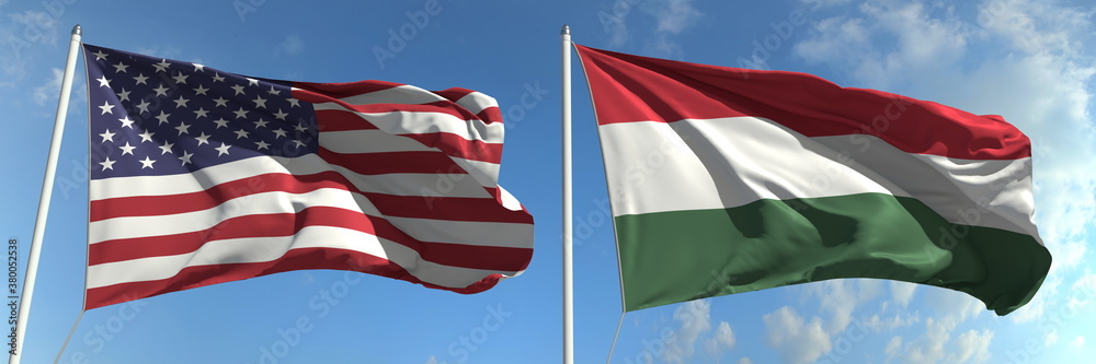 Flags of the USA and Hungary on flagpoles. 3d rendering