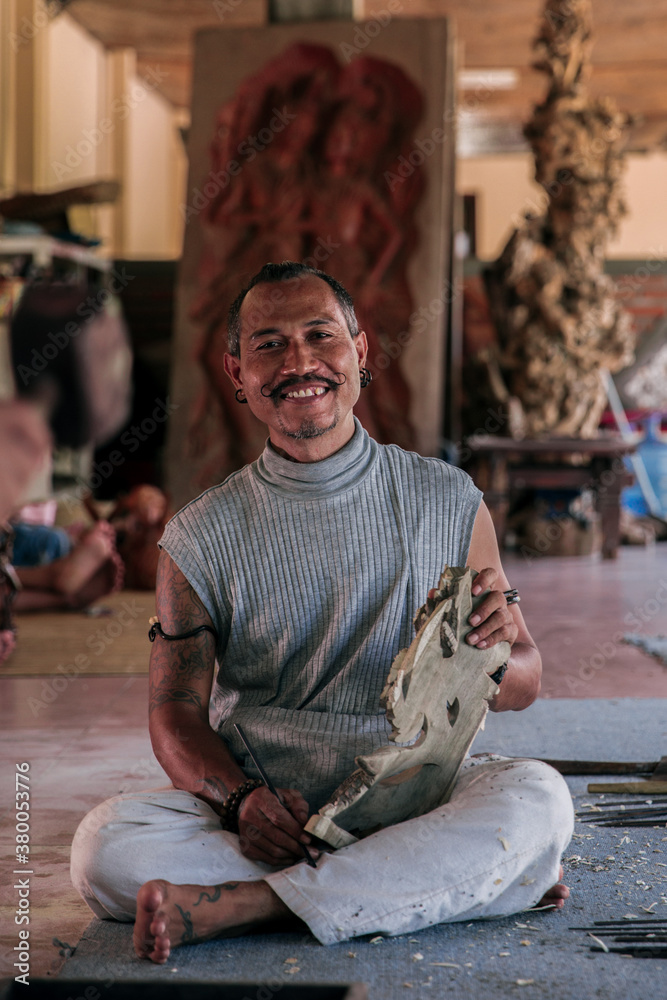 Portrait of a wood carving master with his wooden sculpture Portrait of a wood carving master with his wooden sculpture
