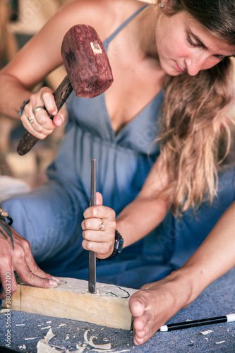 Woman at the wood carving workshop photo