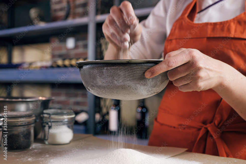 Person sifting flour