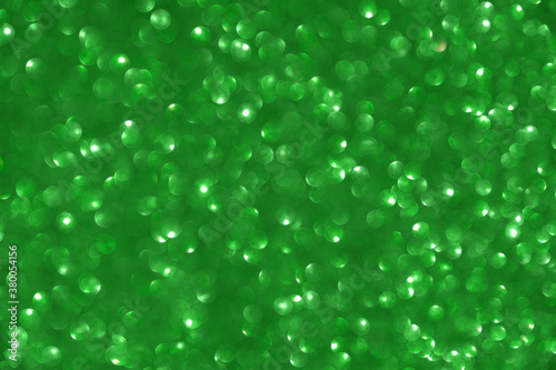 Glamor green sparkling background. Blured glitter background. 