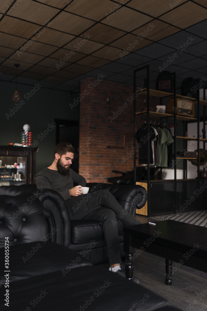 Young bearded man enjoying a cup of coffee Young bearded man enjoying a cup of coffee