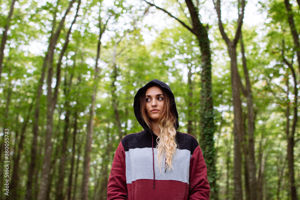 Portrait of woman in the forest between trees