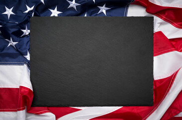 Blank slate board over American flag as a concept for US national celebrations