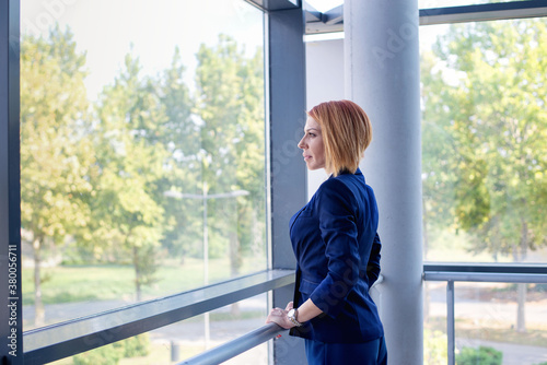 Thoughtful businesswoman looking through window in office Free Download Thoughtful businesswoman looking through window in office - GFXLoad