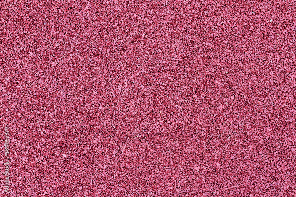 Fototapeta premium Rubber crumb coating for safe sports activities on the Playground. Background of red rubber crumb to soften the impact of sports.