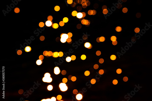 Orange and yellow bokeh. Beautiful defocused lights background. Christmas lights and celebrations.