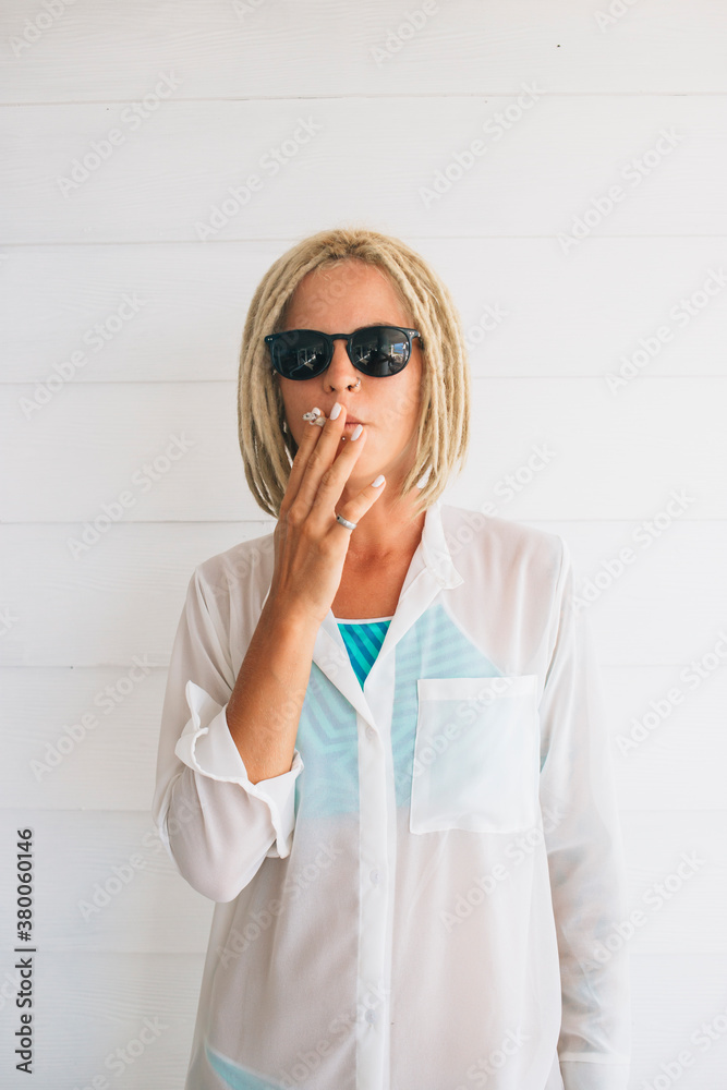 Woman smoking infront of white background Woman smoking infront of white background