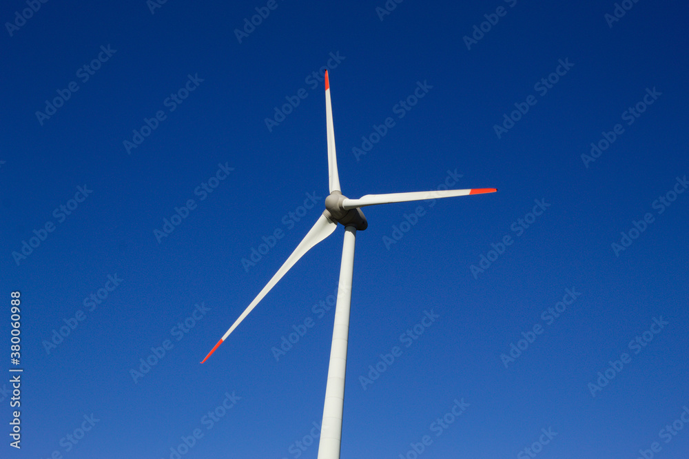 Wind generator with blue sky in the background Wind generator with blue sky in the background