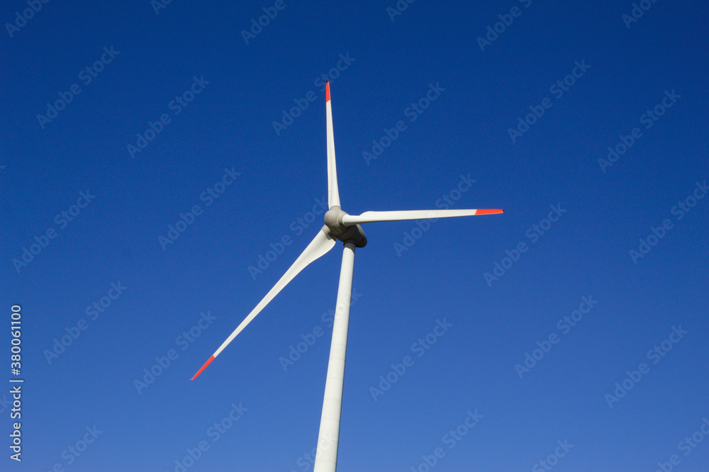 Wind generator with blue sky in the background Wind generator with blue sky in the background