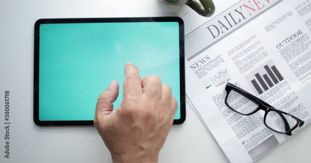 hand holding tablet pc with news hand holding tablet pc with news