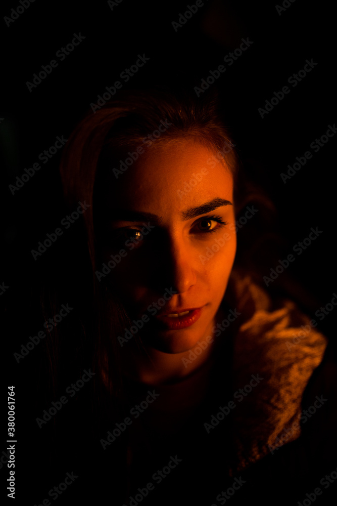 Portrait of a woman in a dark room