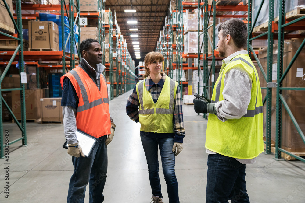 Workers in distribution warehouse. Workers in distribution warehouse.