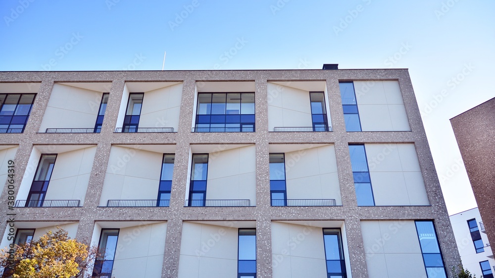 Obraz premium Multistoried modern, new and stylish living block of flats. Newly built apartment building.