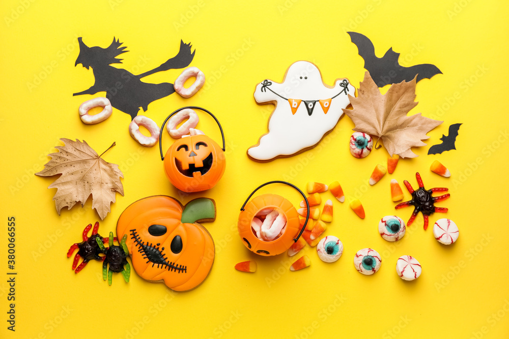 Halloween composition with tasty treats on color background
