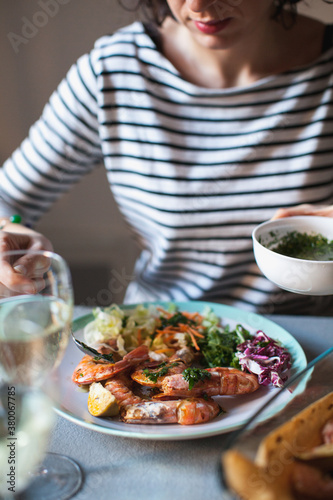Wallpaper Mural Woman eating a shrimp dish with salad Torontodigital.ca