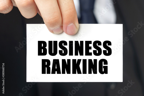 Businessman shows a card with the text - BUSINESS RANKING