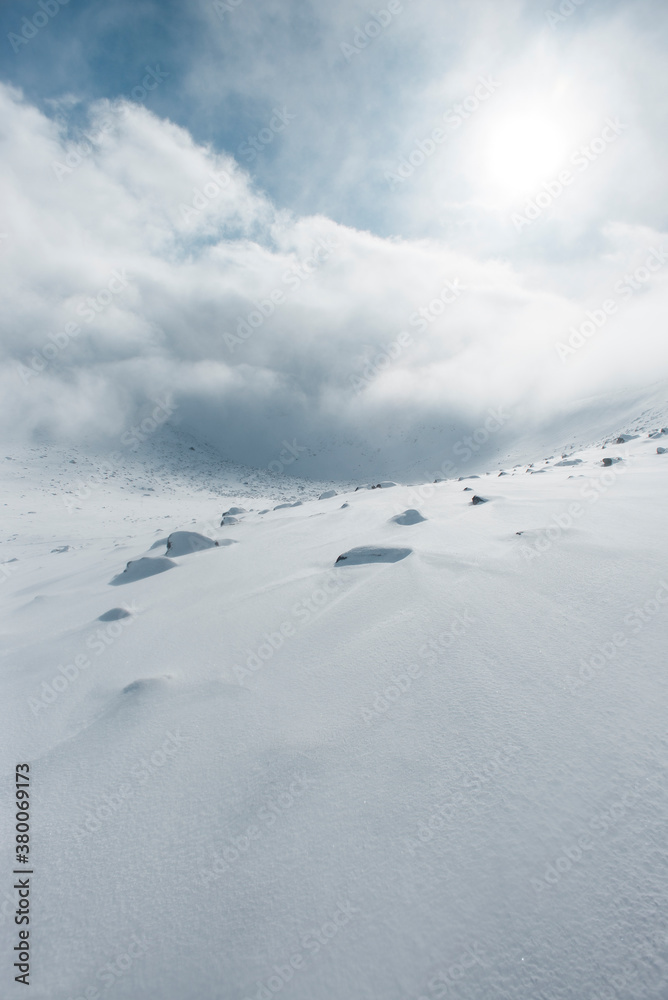 Windswept snow covered mountain landscape Windswept snow covered mountain landscape