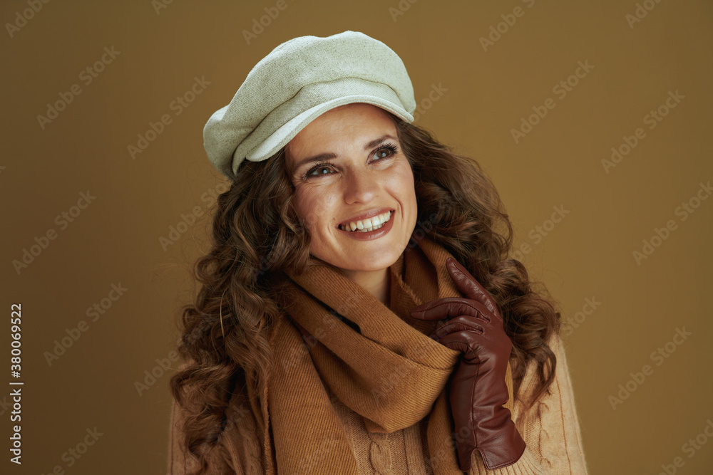 pensive young woman in scarf isolated on beige background pensive young woman in scarf isolated on beige background