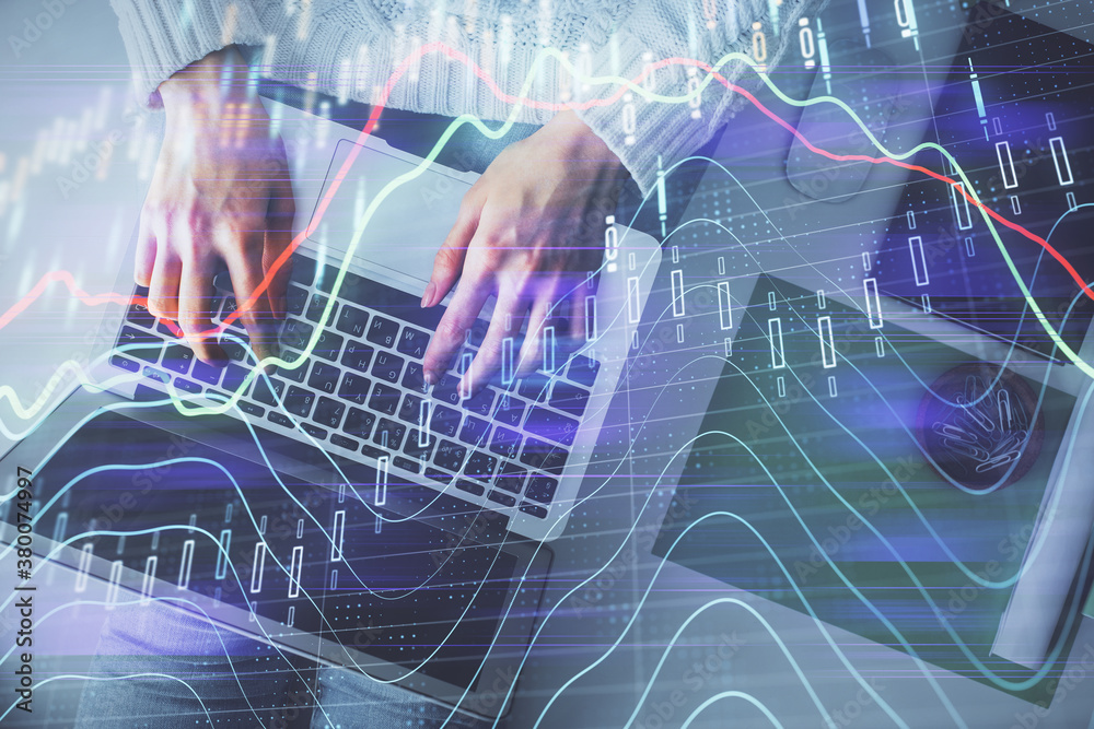 Multi exposure of woman hands working on computer and forex chart hologram drawing. Top View. Financial analysis concept.