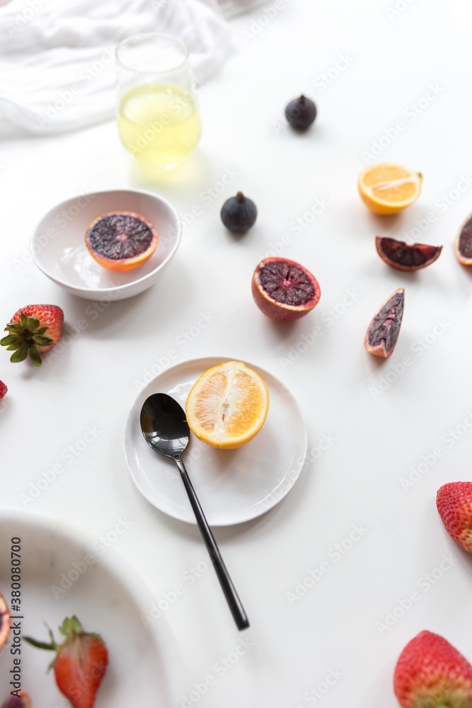 Flat lay of fresh fruit on plate and white surface Flat lay of fresh fruit on plate and white surface