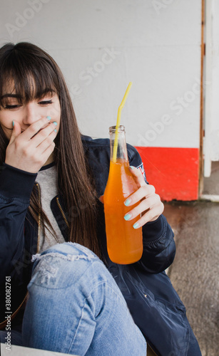 teenager drinking orange soda pop