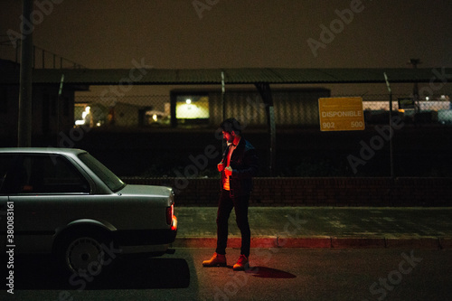 Man in headlight near the trunk