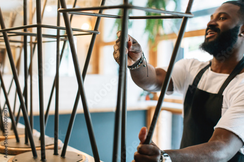 Portrait of a young black man working in a pastrami sandwich bar. photo