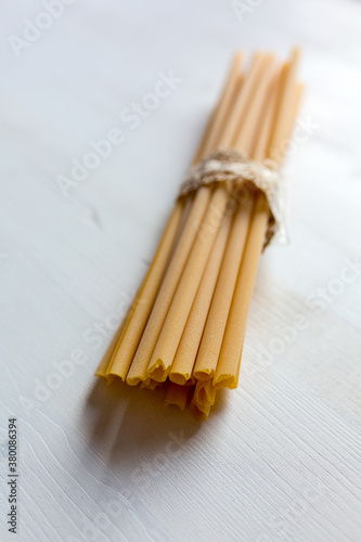 Italian pasta: zitoni from Apulia on a white wooden table photo