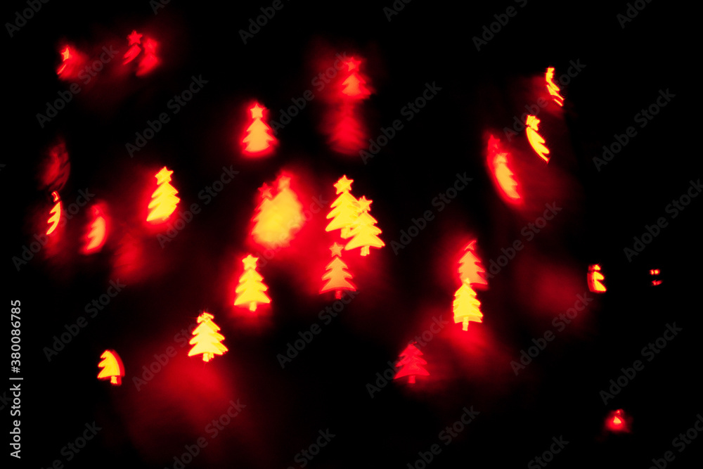 Bokeh in the shape of a Christmas tree. New year background. Selective focus Bokeh in the shape of a Christmas tree. New year background. Selective focus