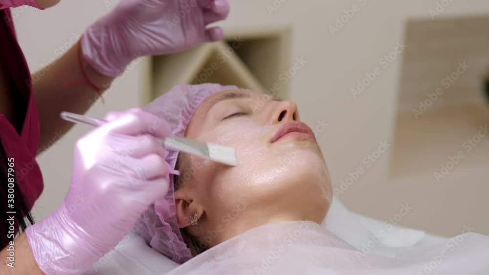 Cosmetologist makes the Rejuvenating facial injections procedure for tightening and smoothing wrinkles on the face skin of young woman in a beauty salon Cosmetologist makes the Rejuvenating facial injections procedure for tightening and smoothing wrinkles on the face skin of young woman in a beauty salon