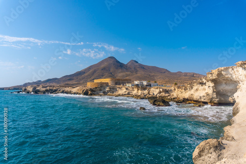 The coast and the castle of Playa los Escullos in the natural park of Cabo de Gata, Nijar, Andalucia. Spain, Mediterranean Sea photo