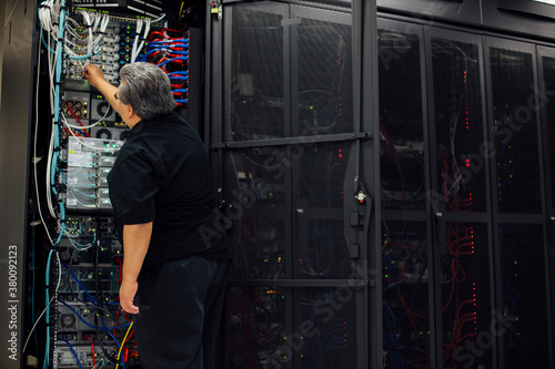 IT computer expert solving problems in server room
