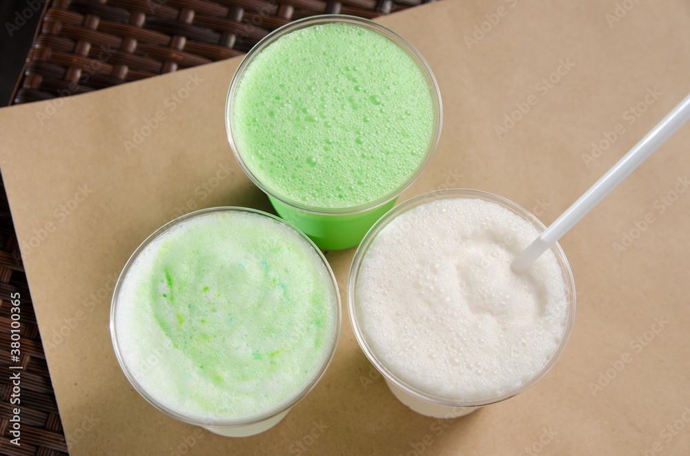 white and green milkshakes in transparent cups with a straw white and green milkshakes in transparent cups with a straw