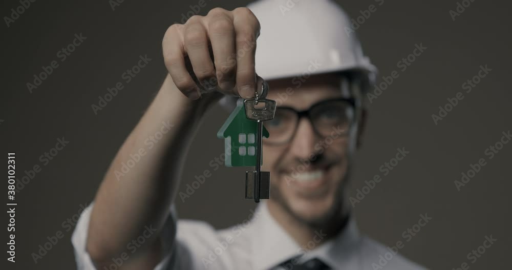 Real estate agent holding house keys Real estate agent holding house keys