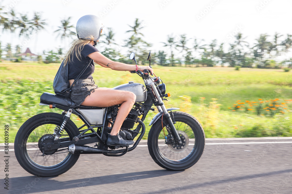 Freedom rider - woman riding cafe racer Freedom rider - woman riding cafe racer