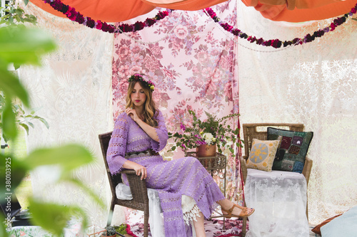 Woman sitting in whimsical fabric tent photo