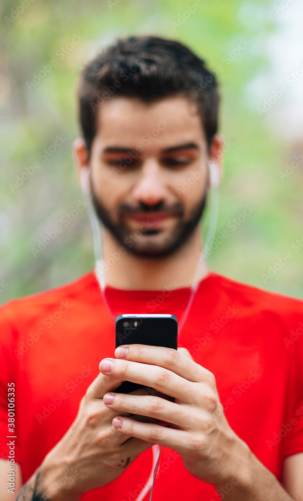 Man using smartphone before running Man using smartphone before running