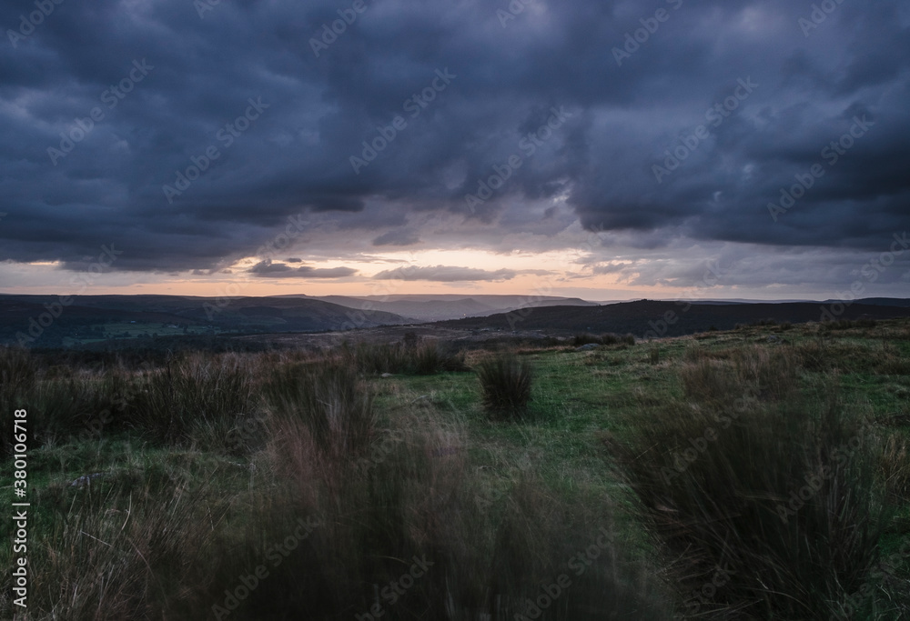 Storm clouds over a windswept moorland at dusk. Derbyshire, UK. Storm clouds over a windswept moorland at dusk. Derbyshire, UK.