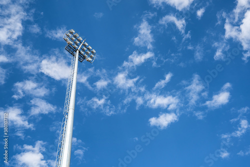 Close up vief of a floodlight in a professional sportsfield. with daylight cloudy blue sky. 