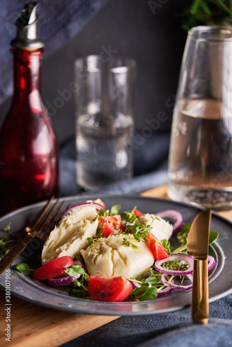 Tomato and mozzarella salad with red onion and watercress. photo