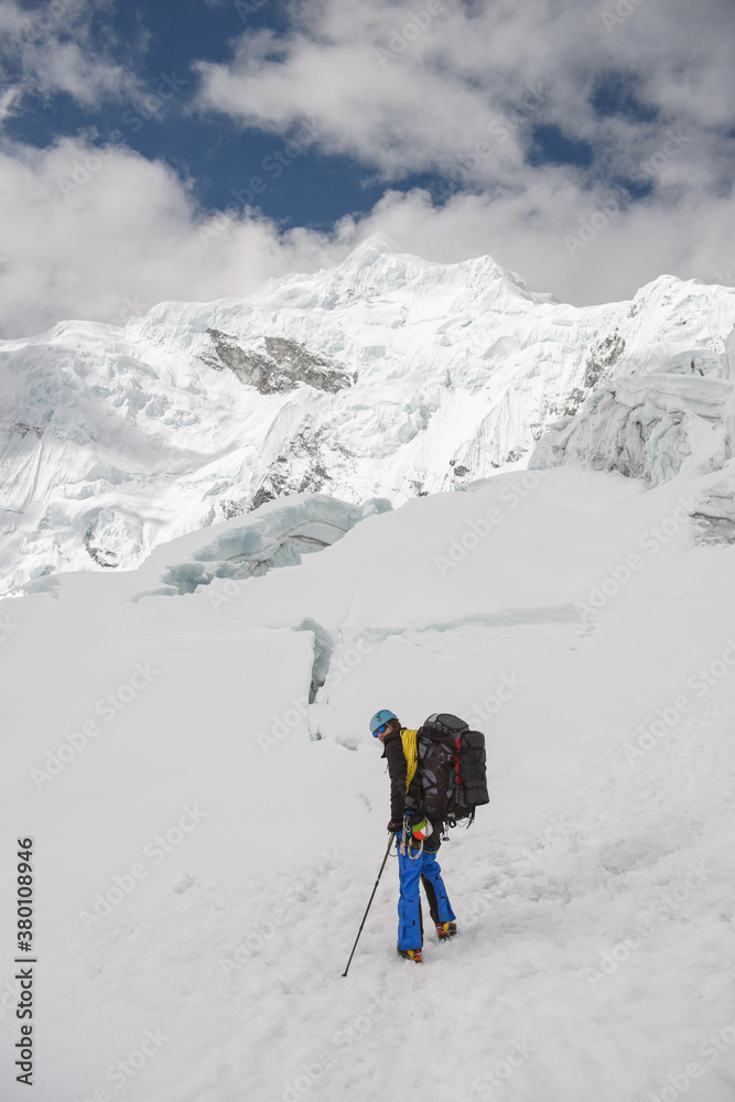 Man exploring snow capped mountain plateau Man exploring snow capped mountain plateau