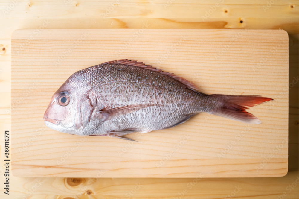 Tai, japanese seabream on wooden cutting board Tai, japanese seabream on wooden cutting board