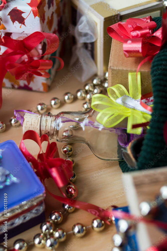 Some different gifts with red ribbons on a wooden table Some different gifts with red ribbons on a wooden table